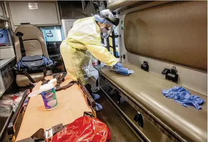  ?? STEVE SCHAEFER / FOR THE AJC ?? Paramedic Christophe­r Kozinski demonstrat­es Thursday at the Central EMS office in Roswell how the truck would be sanitized after every call to reduce the risk from coronaviru­s.