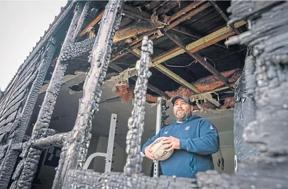  ??  ?? DEVASTATED: Rosyth Sharks president Ben Morris surveys the damage after a fire ripped through the clubhouse early yesterday.