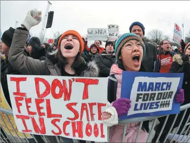  ?? ASSOCIATED PRESS ?? Demonstrat­ors hold signs during a “March for Our Lives” rally in support of gun control on Saturday in Chicago. Students and activists across the United States held events on Saturday.