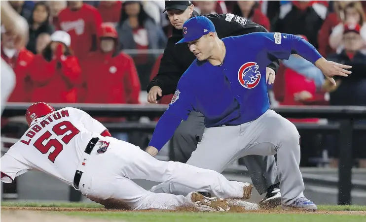  ?? — THE ASSOCIATED PRESS ?? Chicago Cubs first baseman Anthony Rizzo picks off Washington Nationals catcher Jose Lobaton during the eighth inning on Thursday in Washington, D.C.