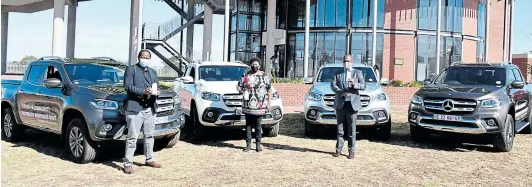  ?? Pictures: MANDLA NDUNA /ECOTP ?? POWER WHEELS: Mercedes Benz SA’s executive director for human resources and corporate affairs, Abraham Kgotle, health MEC Sindiswa Gomba and Premier Oscar Mabuyane standing infront of four Mercedes Benz X Class vehicles donated to the Eastern Cape government to empower the province’s war on Covid-19. The German automaker also donated 3,000 face shields, 20,000 surgical masks and 2,000 bottles of alcohol-based sanitisers.