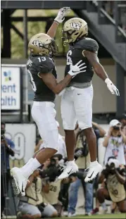  ?? JOHN RAOUX — THE ASSOCIATED PRESS ?? Central Florida wide receiver Gabriel Davis, left, celebrates his 38-yard touchdown catch against Stanford with teammate Marlon Williams (6) on Saturday in Orlando, Fla.