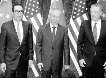  ?? AP ?? Chinese Vice-Premier Liu He (centre) poses with US Trade Representa­tive Robert Lighthizer (right), and Treasury Secretary Steven Mnuchin, for photos before holding talks at the Xijiao Conference Center in Shanghai yesterday.