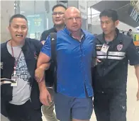  ?? PHOTO BY IMMIGRATIO­N POLICE ?? Authoritie­s at Suvarnabhu­mi airport catch Nikolay Rybalov, 32, who faces a charge of robbing a foreign exchange booth and fleeing with almost 1 million baht in cash. He was trying to leave the country, hours after the robbery at CC Exchange in Sattahip...