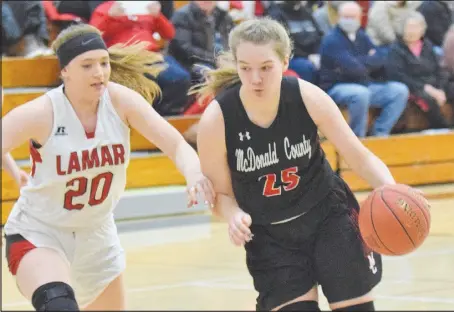  ?? RICK PECK/sPECIAL to MCDoNALD CoUNty PREss ?? McDonald County’s Samara Smith drives past Lamar’s Eli Daniels during the Lady tigers 29-27 win on Feb. 13 at Lamar high school.