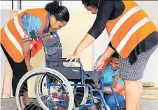  ?? ?? Participan­ts repair a damaged wheelchair generated through a 3D printer.