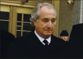  ?? LOUIS LANZANO — THE ASSOCIATED PRESS ?? Bernard Madoff exits court in New York in 2009. The convicted swindler died of natural causes Wednesday.