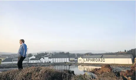  ?? /Reuters ?? Giving a dram: The Laphroaig whisky distillery is perched at the sea’s edge on the Hebridean island of Islay, Scotland. The tiny island, famed for its peated whiskies, is home to eight distilleri­es.