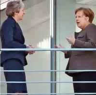  ??  ?? ‘Begging gesture’: She speaks to Mrs Merkel