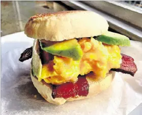  ?? WYATT WILLIAMS ?? The Egg McMuff at 8arm is loaded with soft scrambled egg, avocado, bacon and cilantro-Tabasco mayo.