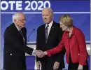  ?? CHARLES KRUPA — THE ASSOCIATED PRESS ?? From left, Sen. Bernie Sanders, I-Vt., shakes hands with Sen. Elizabeth Warren, D-Mass., as former Vice President Joe Biden looks on.