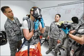  ?? TY GREENLEES / STAFF 2012 ?? Students at the U.S. Air Force School of Aerospace Medicine practice hazardous materials scenarios in the apprentice program. They wore full hazmat suits with a respirator to complete site reconnaiss­ance health risk assessment training.