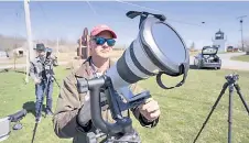  ?? ?? John Bills tests his camera equipment on the eve of a total solar eclipse.