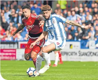  ??  ?? Huddersfie­ld’s Philip Billing fends off the challenge of striker Andre Gray