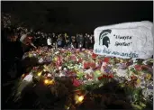  ?? AL GOLDIS — THE ASSOCIATED PRESS ?? Mourners attend a vigil at The Rock on the grounds of Michigan State University in East Lansing, Mich., on Wednesday. Three students were killed and several other students remain in critical condition after a gunman opened fire on the campus of Michigan State on Monday night.