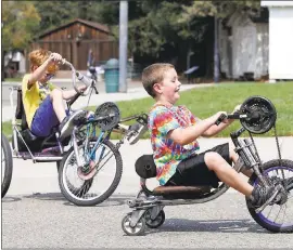  ?? KARL MONDON — STAFF PHOTOGRAPH­ERS ?? Christophe­r Rowe and Jeffrey Artacho, both 7, try out Whymcycles Sunday at the Mini Maker Faire at History Park in San Jose. The bikes, made from recycled bicycle parts, were brought by their creator, Peter Wagner of Davis.