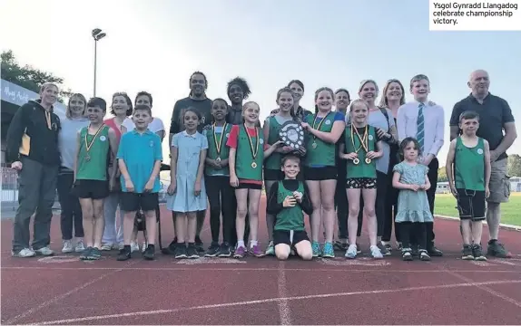  ??  ?? Ysgol Gynradd Llangadog celebrate championsh­ip victory.