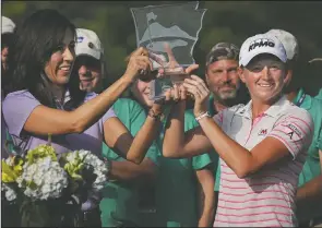  ?? Stacy Lewis, right, holds up the trophy during a ceremony on the 18th green following the final round of the Walmart NW Arkansas Championsh­ip presented by P&G at Pinnacle Country Club in Rogers on Sunday, June 29, 2014. (NWA Democrat-Gazette/ Ben Goff) ??