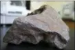  ?? MACKENZIE BROCKMAN — CENTRAL MICHIGAN UNIVERSITY VIA AP ?? This 22-plus pound meteorite was being used as a doorstop on a farm in Edmore, Mich.