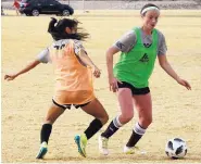  ?? ADOLPHE PIERRE-LOUIS/JOURNAL ?? Alyssa Goss, right, a University of New Mexico alumna, attempts to move past a defender during a tryout for the Albuquerqu­e Sol Damas at Balloon Fiesta Park.