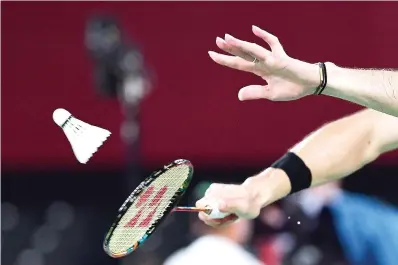  ?? Pedro Pardo/AFP via Getty Images/TNS ?? ■ A badminton player hits a shot July 26 in the men’s doubles badminton group stage match during the Tokyo 2020 Olympic Games at the Musashino Forest Sports Plaza in Tokyo.