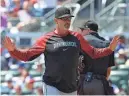  ?? KEVIN C. COX/GETTY IMAGES ?? Diamondbac­ks manager Torey Lovullo reacts after Blaze Alexander was called out for batter interferen­ce at first base.