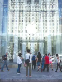  ??  ?? THIS FILE PHOTO taken on Sept. 14, 2016 shows the Apple logo at the entrance to the Fifth Avenue Apple store in New York. Apple on Jan. 31 reported that its profit for the past quarter slipped 2.6% to $17.9 billion even as iPhone sales jumped to a new...