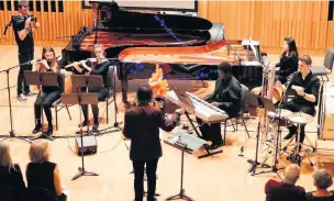  ??  ?? ●●John, top and above, conducting at Chethams college in Manchester