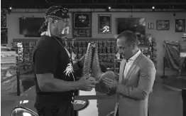  ?? COURTESY OF FOX NEWS CHANNEL ?? Hulk Hogan — owner of Hogan’s Beach Shop in Orlando, left — shows off his wrestling boots to host Harvey Levin on Fox News’ “Objectifie­d,” airing 8 p.m. Sunday.