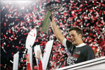  ?? The Associated Press ?? Tampa Bay Buccaneers quarterbac­k Tom Brady holds the Vince Lombardi trophy following Super Bowl 55 against the Kansas City Chiefs, Sunday, in Tampa, Fla. Tampa Bay won 31-9.