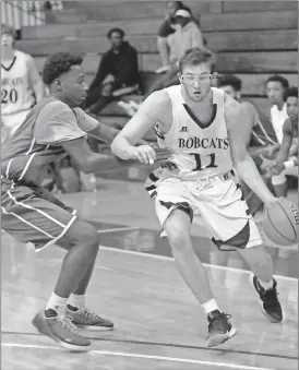  ??  ?? Bryce Waters drives toward the hoop during last week’s home opener against the Hiwassee College JV team. Waters scored the final five points in the Bobcats’ 71-67 victory. (Photo by Scott Herpst)