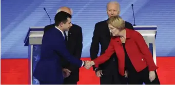  ?? AP ?? PUBLIC FACES: Everyone’s all smiles as Pete Buttigieg, left, shakes hands with Elizabeth Warren and Bernie Sanders and Joe Biden, back from left, look on, But what might they be saying when the cameras are off?