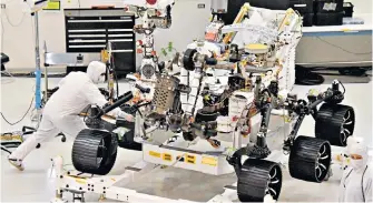  ??  ?? Technician­s with the Mars 2020 rover at the Jet Propulsion Laboratory in Pasadena, USA. Following a mid-year launch, it is due to land on Mars in February 2021.