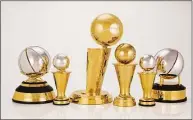  ?? Jennifer Pottheiser / Associated Press ?? This photo provided by the NBA shows a group of trophies. The NBA’s championsh­ip trophy has a new look, and the league is going to be handing out some new trophies for the first time during these playoffs. The league unveiled a redesigned Larry O’Brien Trophy on Thursday, plus announced changes to the Bill Russell NBA Finals MVP trophy and changes to the design of the conference championsh­ip trophies.