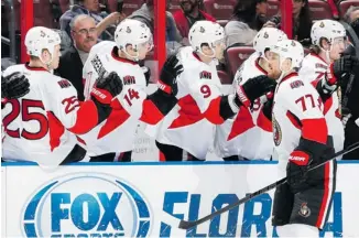  ?? JOEL AUERBACH/GETTY IMAGES ?? Senators defenceman Joe Corvo is congratula­ted by teammates after scoring a first-period goal against the Panthers in Sunrise, Fla., on Tuesday. He also scored the game winner.