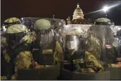  ?? JOHN MINCHILLO — THE ASSOCIATED PRESS ?? Members of the National Guard stand outside the Capitol in Washington on Wednesday night.