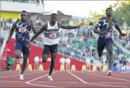  ?? ASHLEY LANDIS — THE ASSOCIATED PRESS ?? Trayvon Bromell, center, captures the men’s 100-meter sprint at the U.S. Olympic Track and Field Trials on Sunday, in Eugene, Ore. It marked a dramatic comeback in his career.