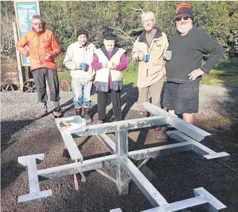  ?? ?? The Katikati Rotary team paused for a cup of tea while installing the Wharawhara Track picnic table, which was soon completed. PHOTO: Supplied.