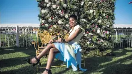  ??  ?? SEASON’S GREETINGS. Horseracin­g fan Given Nefotoni poses for a picture at the Turffontei­n Racecourse on Saturday.