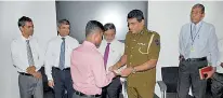  ??  ?? A seizer attended the workshop receiving his certificat­e from Colombo Division SSP and former Police Spokesman Attorney-at-law Ajith Rohana in the presence of (from left) PLC Deputy General Manager Operations Lionel Fernando, DGM Finance and...