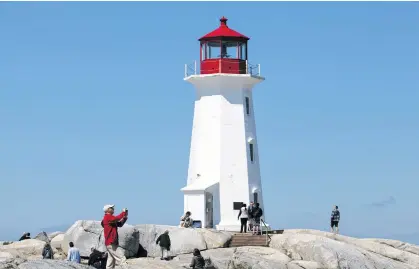  ?? ERIC WYNNE • THE CHRONICLE HERALD ?? Tourists visit Peggys Cove in this file photo from July 2019.