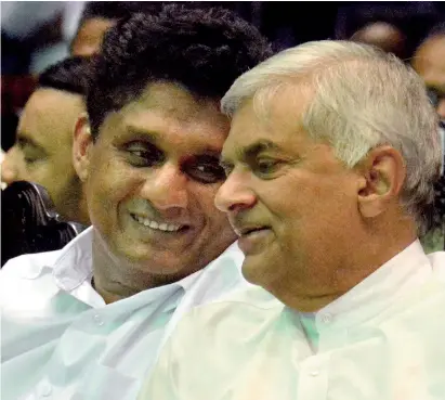  ??  ?? The United National Party leader Ranil Wickremesi­nghe and the party’s presidenti­al candidate and deputy leader Sajith Premadasa in a hearty conversati­on during the party’s National Convention at the Sugathadas­a Indoor Stadium on Thursday. Pic by Indika Handuwela