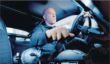  ?? Universal Pictures ?? VIN DIESEL is all business behind the wheel as Dom in the eighth installmen­t of the blockbuste­r series “The Fast and the Furious.”