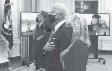  ?? ALEXWONG/GETTY ?? First lady Jill Biden, right, President Joe Biden, Vice President Kamala Harris and second gentleman Doug Emhoff listen to the national anthem Thursday as they watch the virtual presidenti­al inaugural prayer service at the White House.