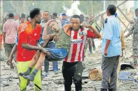  ?? REUTERS ?? A man injured in a suicide car bomb explosion in Mogadishu being taken away.