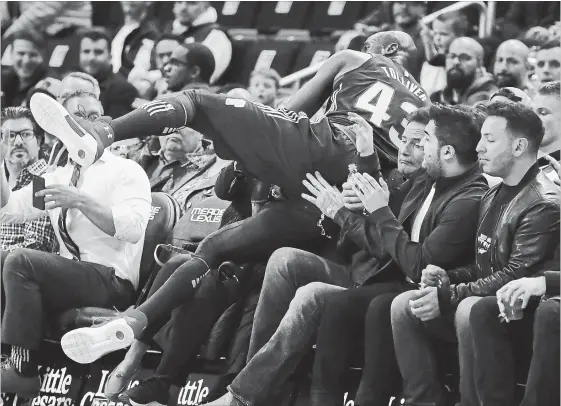  ?? CARLOS OSORIO THE ASSOCIATED PRESS ?? Pistons forward Anthony Tolliver falls into the seats after chasing the ball during the first half of their loss to the visiting Toronto Raptors on Monday night in Detroit.