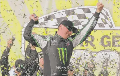  ?? | NAM Y. HUH/AP ?? Kyle Busch experience­s the thrill of victory after leading 195 of 200 laps to easily win the NASCAR Nationwide Series race Saturday at Chicagolan­d Speedway. Busch also won the truck race on Friday and will start 12th in Sunday’s Geico 400.