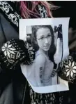  ?? CANADIAN PRESS FILES ?? A woman holds a photo of Rehtaeh Parsons at a community vigil in Halifax last April.