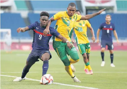  ?? /Gallo Images ?? Nathanael Mbuku of France, left, battles for possession of the ball with Katlego Mohamme at the Olympic Games in Japan this week.