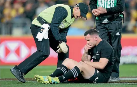  ?? GETTY IMAGES ?? Ryan Crotty is attended to by All Blacks doctor Tony Page after being knocked out in the test against the Wallabies in Sydney last month.